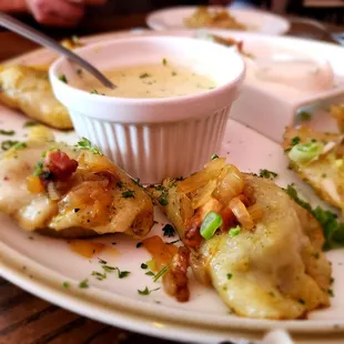 a plate of dumplings with dipping sauce