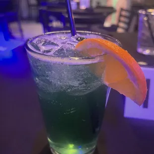 a drink with a slice of orange on the rim