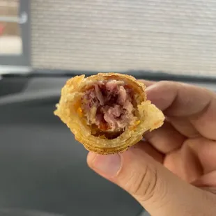 a hand holding a pastry