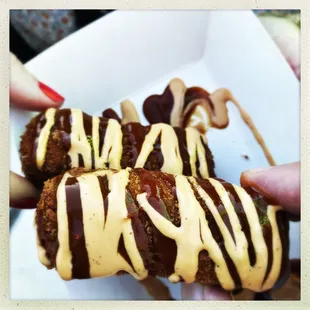 a person holding a piece of food