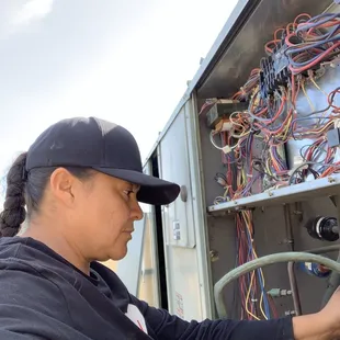 Ana servicing a air conditioner