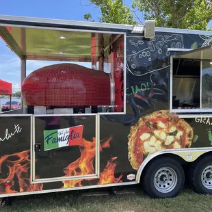 QZO red pizza oven at rear of food truck