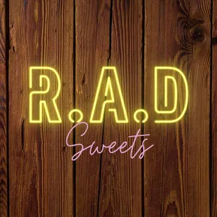 a neon sign that reads r a d sweets