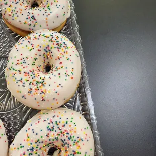 four frosted donuts with sprinkles