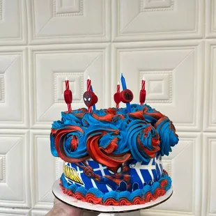 a hand holding a decorated cake