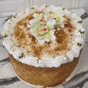 a cake decorated with bees and flowers