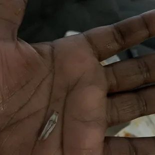 a person&apos;s hand holding a piece of food