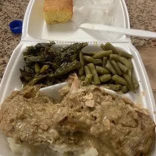 Smothered pork chops, mashed potatoes, greens and string beans.... corn bread on the side...