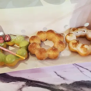 Strawberry matcha, churro, and creme brule donuts