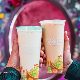 a hand holding two cups