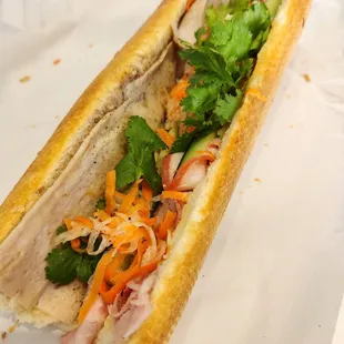 a sub sandwich with meat and vegetables