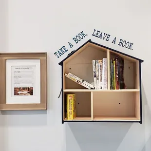 a shelf with books and a picture frame