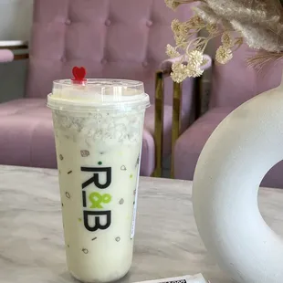 a drink in a plastic cup on a table
