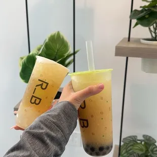 Left: lychee green tea with aloe Vera and lychee jelly  Right: Peach Yakult with boba