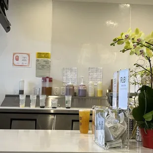 a counter with a vase of flowers