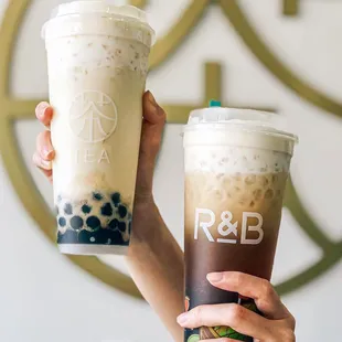 two people holding up their drinks