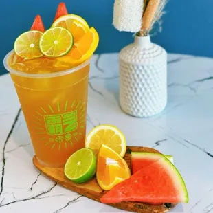 a glass of iced tea and slices of watermelon