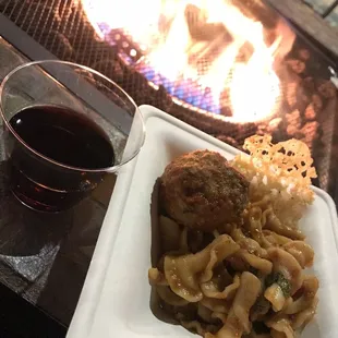 a plate of food and a glass of wine