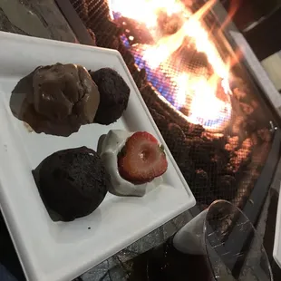 a plate of desserts and a glass of wine