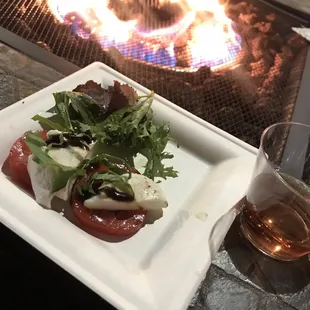 a plate of food and a glass of wine