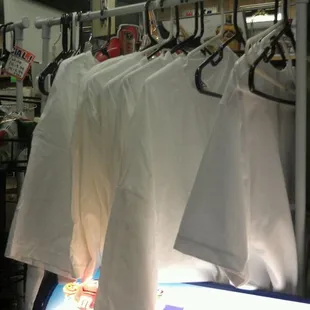 White tees on racks.