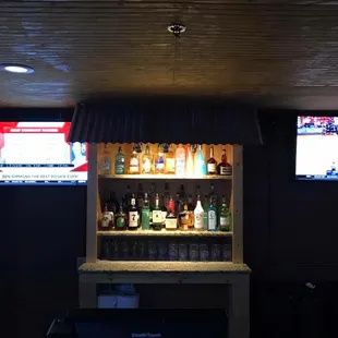 a bar with several bottles of alcohol