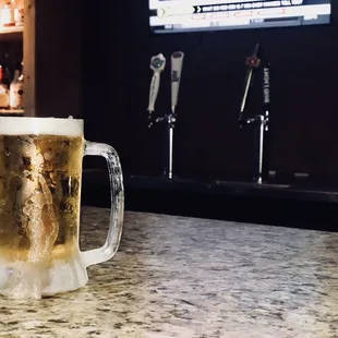 a mug of beer on a bar counter