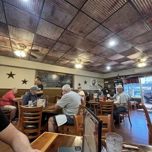 people sitting at tables in a restaurant
