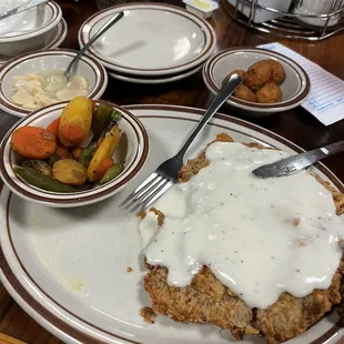 Chicken fried steak lunch special with buttered beans, corn nuggets, and grilled vegetables.