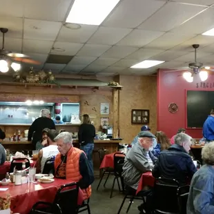 people sitting at tables in a restaurant