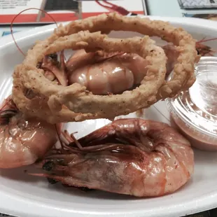 Taste plate with boiled shrimp and onion rings with a Tobasco based dipping sauce