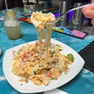 a plate of pasta with a fork