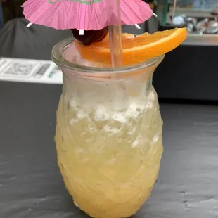 a drink with a pink umbrella
