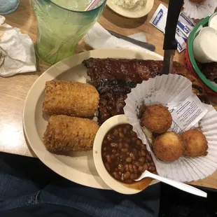 Fries corn, hush puppies and ribs/ pork