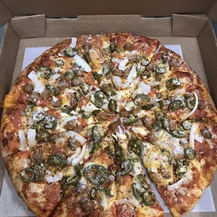 Pepperoni, sausage, onion, and jalapeño pizza ready to go!