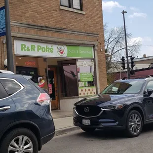two cars parked in front of a store