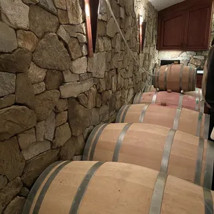 barrels lined up against a stone wall