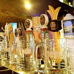 a row of beer glasses on a bar