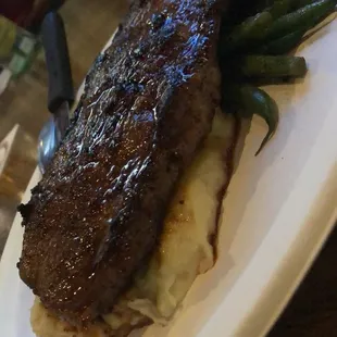 Ribeye steak, mashed potatoes and green beans.