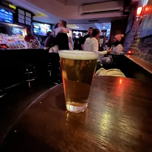 a pint of beer on a table