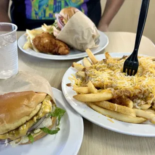 Our late lunch. 2 cheeseburgers, chili cheese fries and chicken strips.