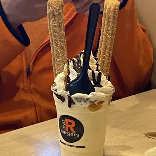 a person taking a picture of their dessert
