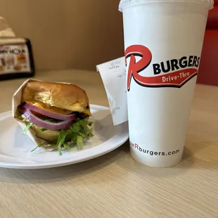 a burger and a drink on a table