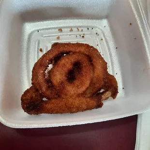 What&apos;s left of a petrified small onion ring. So burnt and over salted