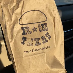 a brown paper bag with a burger on it