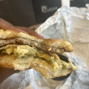 Sausage egg and cheese on a brioche bun. Side of maple syrup