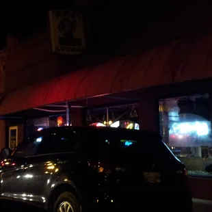 a car parked in front of a restaurant