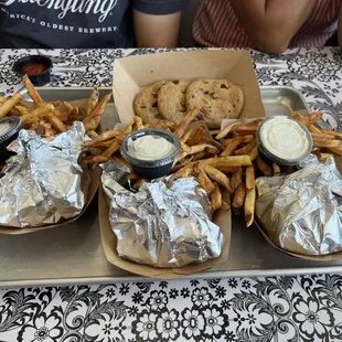 a tray of fries and a tray of dips