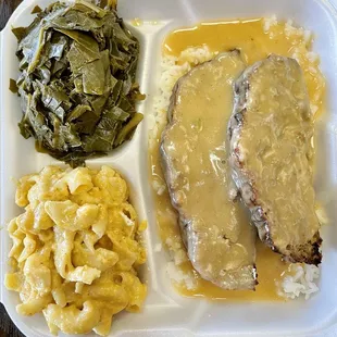 Beef meatloaf dinner with Mac n cheese and collard greens.