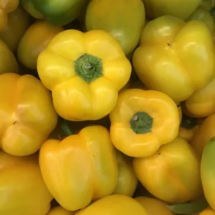 a large pile of yellow peppers